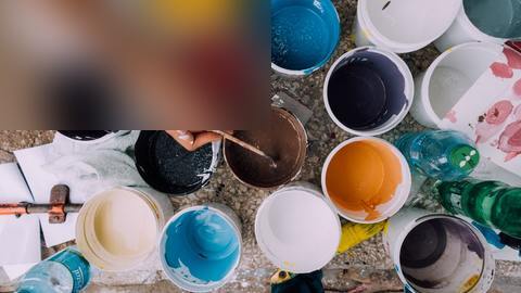tins-of-paint-and-hand-with-paintbrush